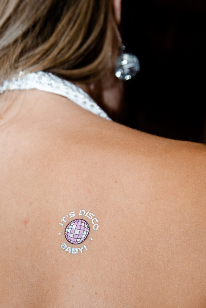 Bride wearing a It's Disco baby tattoo
