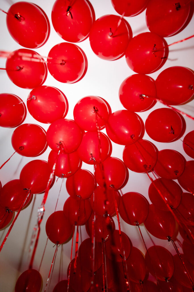 Red balloon ceiling installation for a Lucky in Love inspired Las Vegas bachelorette party