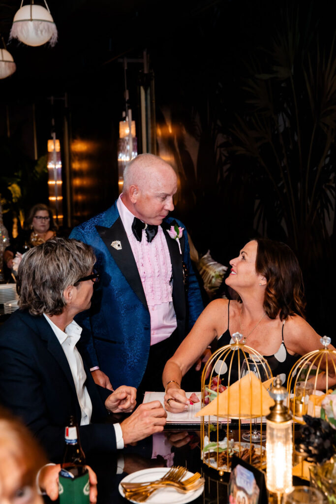 Groom chatting with wedding guest during Las Vegas reception at Pinky’s.