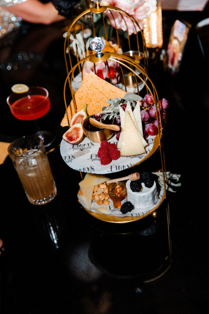 Luxe cheese and fruit display with cocktails served at Pinky’s Vanderpump Las Vegas wedding reception.