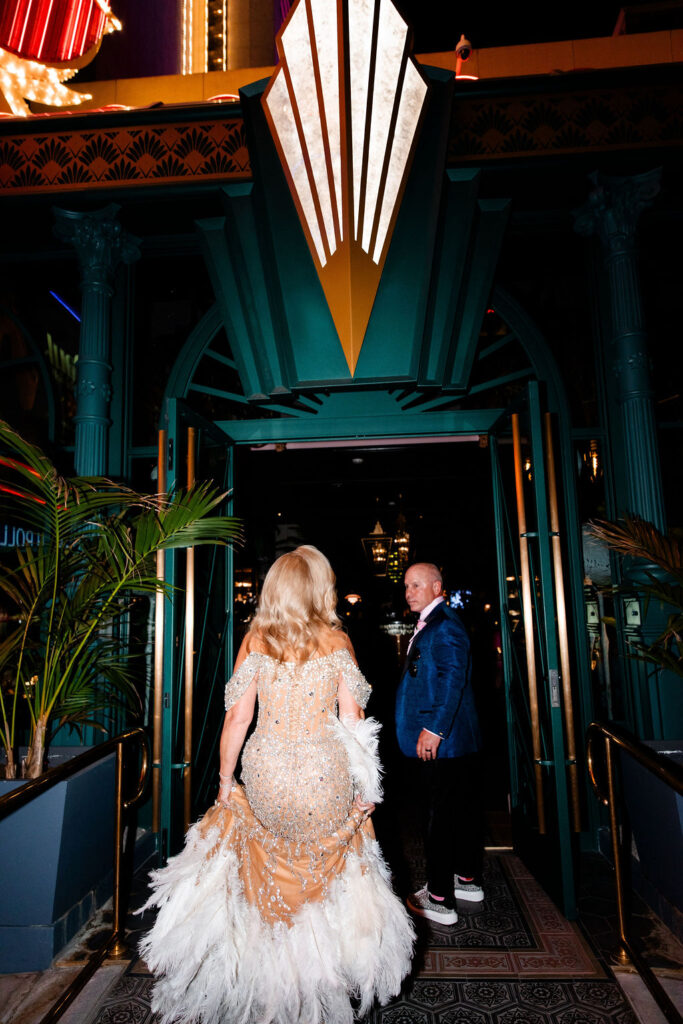 Bride and groom walking into Pinky’s restaurant for their Las Vegas wedding reception.