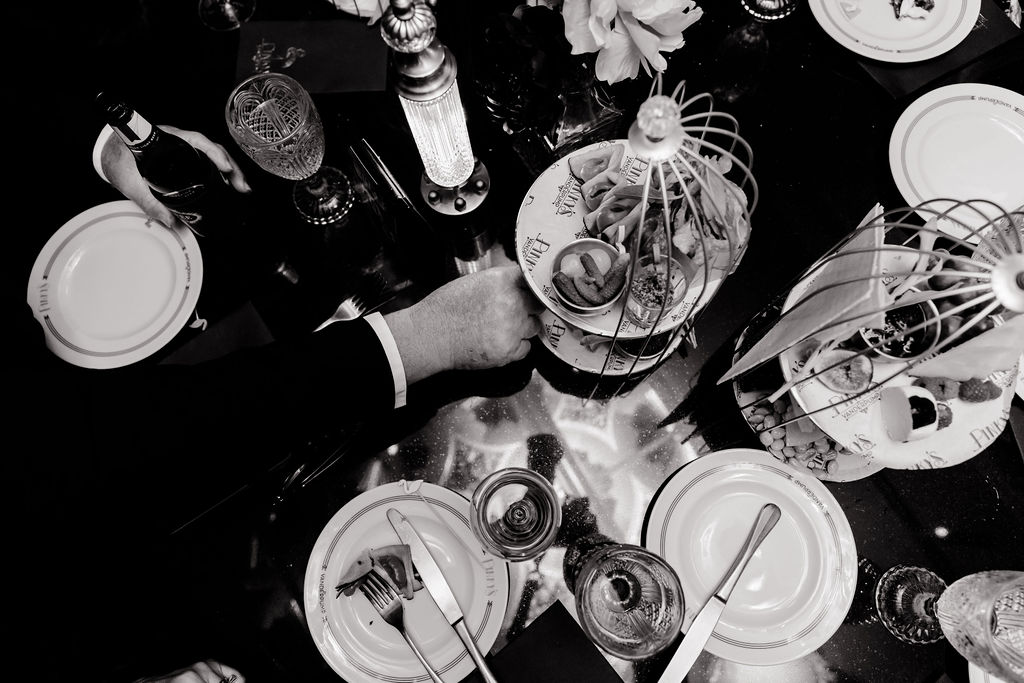 Overhead black-and-white photo of small plates and charcuterie at Pinky’s Vanderpump Las Vegas wedding reception.