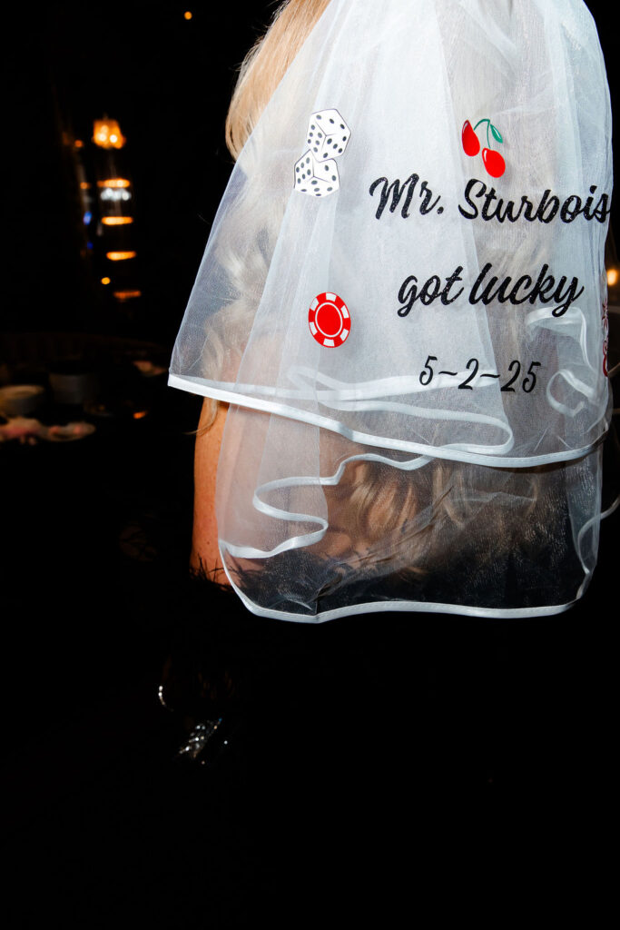 Bride wearing a custom Las Vegas wedding veil with dice, cherries, and casino chips