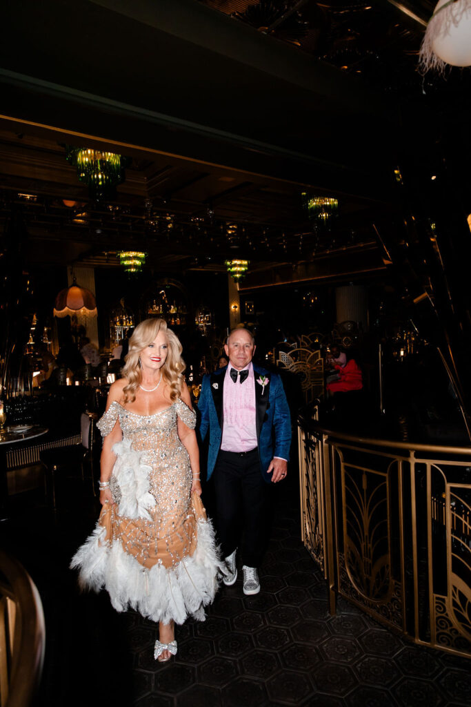 Bride and groom walking hand in hand inside Pinky’s by Vanderpump.
