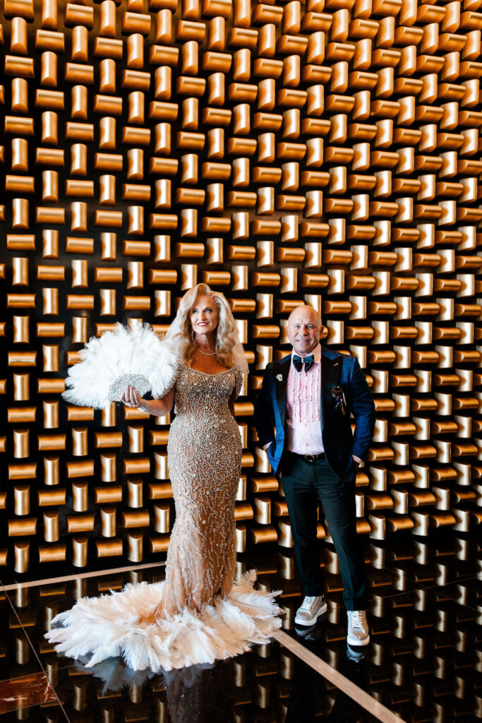 Couples editorial portraits against modern gold wall at Waldorf Astoria Las Vegas