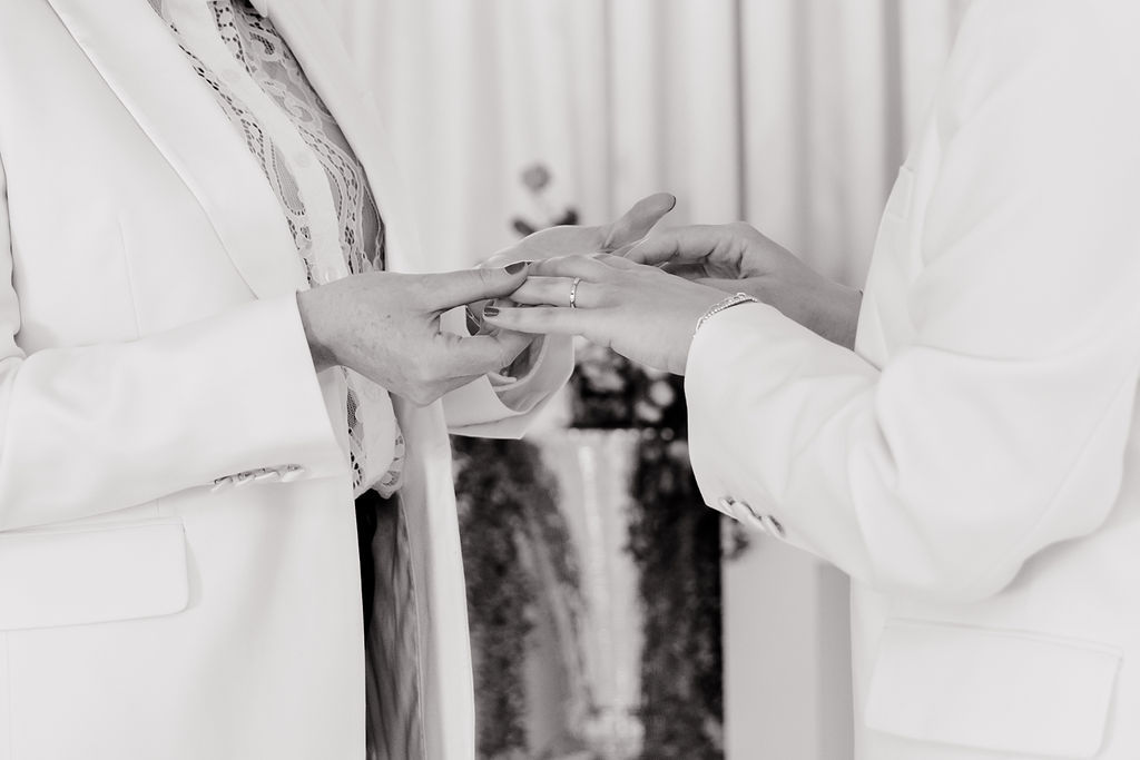 Black and white photo of a couple exchanging rings during their intimate Las Vegas elopement ceremony
