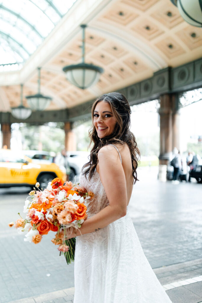 Bride holding a colorful spring bouquet by Mylo Fleur