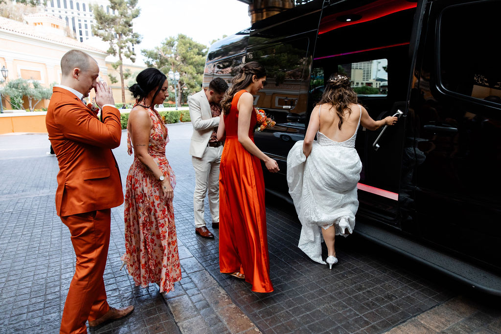 Bride, groom, and their wedding party getting on a party bus