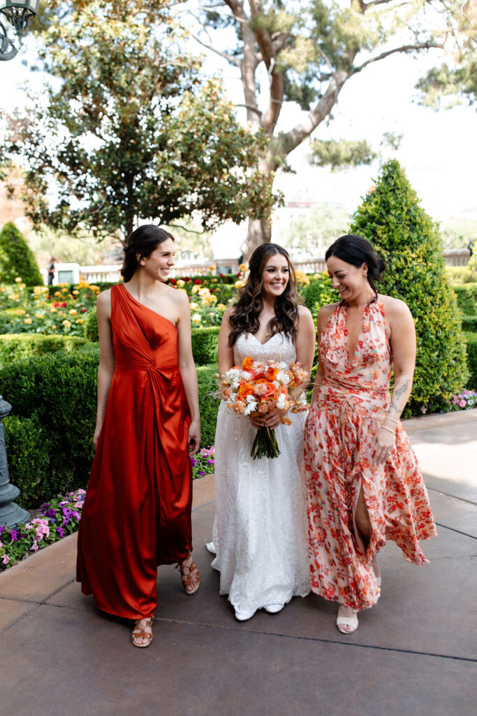 Candid bride and bridesmaids photos in the Bellagio Gardens for a spring Las Vegas micro wedding