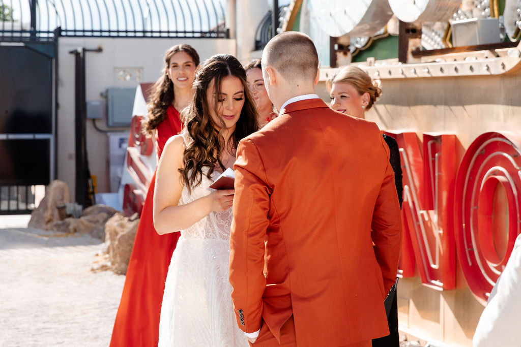 Bride reading her vows during her Neon Museum Las Vegas micro wedding ceremony