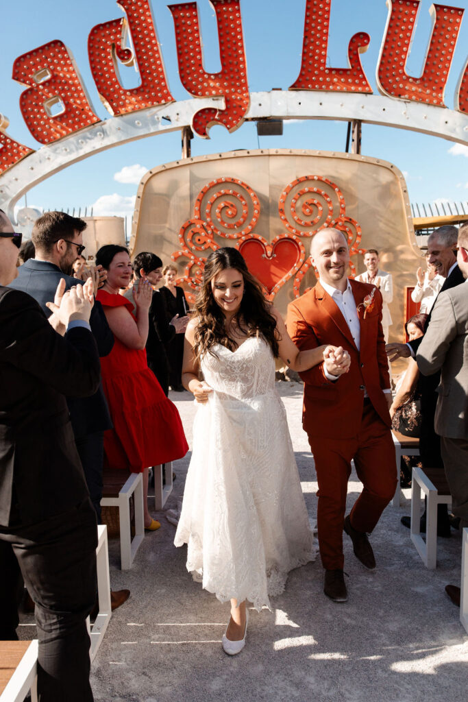 Bride and groom walking back down the aisle as husband and wife after their Neon Museum Las Vegas micro wedding