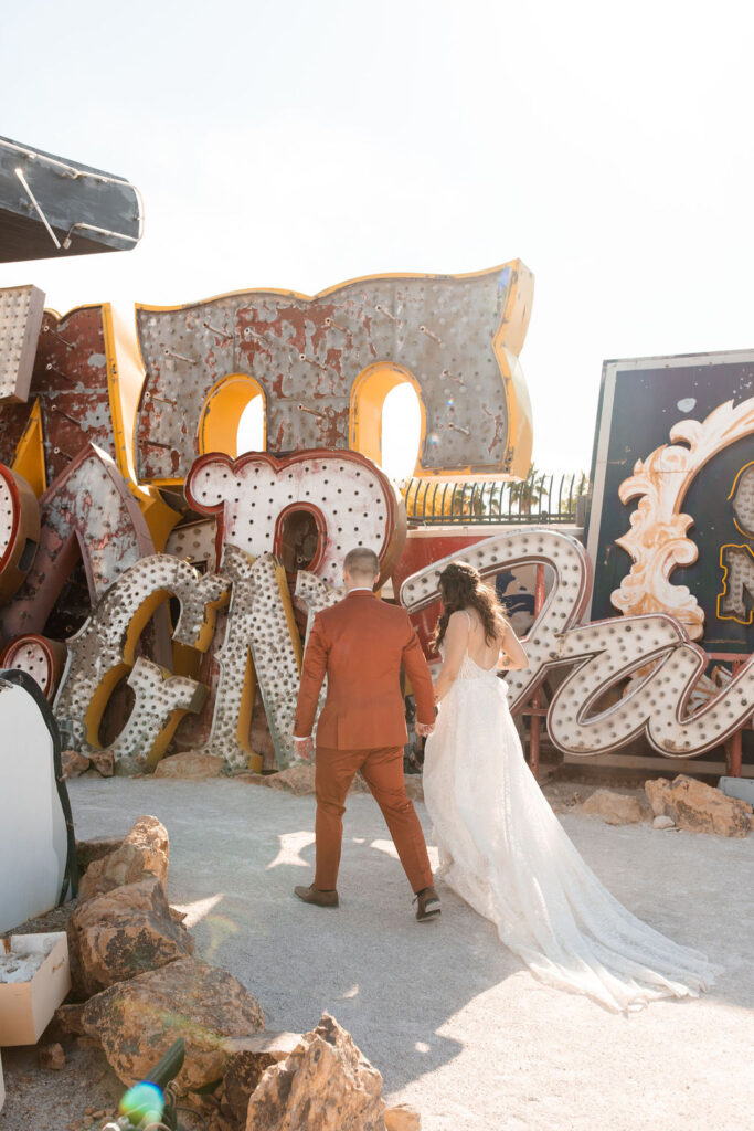 Bride and groom walking together after their Neon Museum Las Vegas micro wedding ceremony