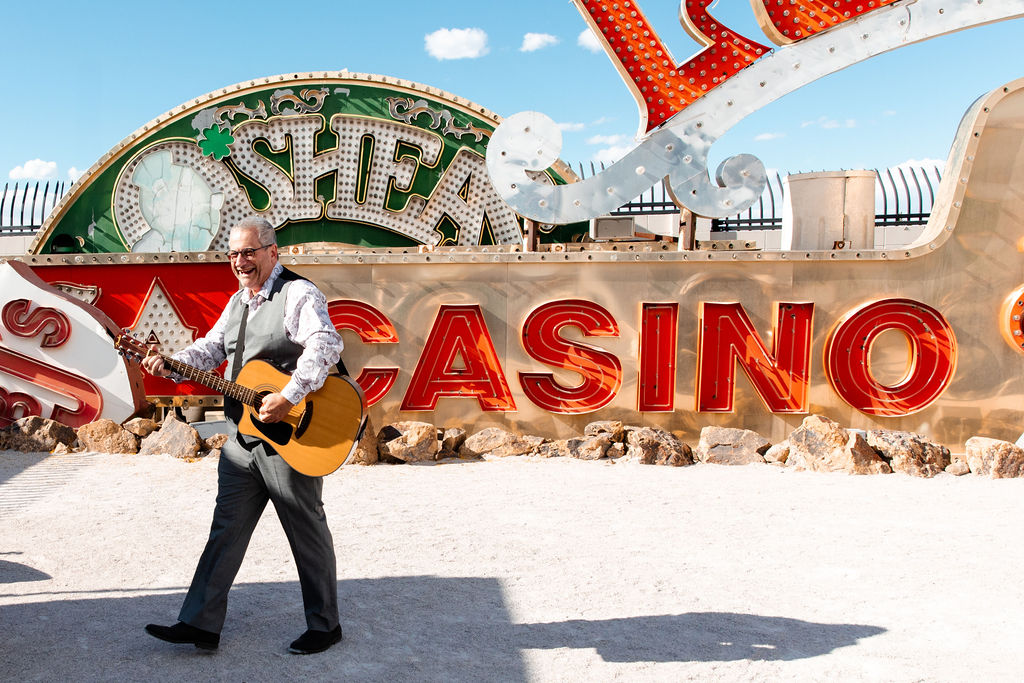 Man playing guitar for a Neon Museum Las Vegas micro wedding