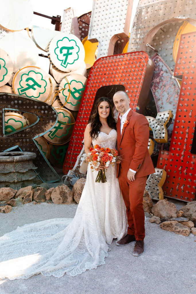 Bride and groom posing at Neon Museum for their Las Vegas micro wedding portraits