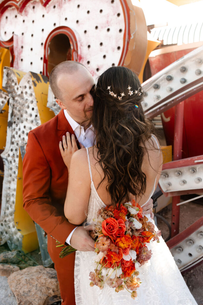 Bride and groom posing at Neon Museum for their Las Vegas micro wedding portraits
