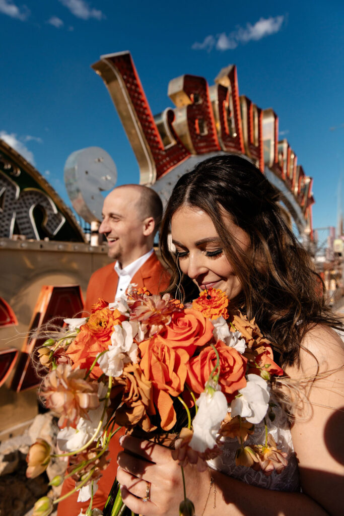 Close up shot of a bride and groom walking together at Neon Museum in Las Vegas