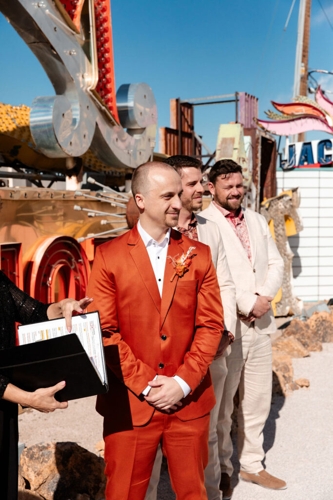 Groom watching his bride walking down the aisle for their Neon Museum micro wedding in Las Vegas