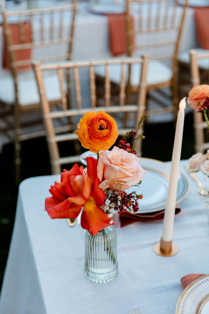 Reception tables decorated with colorful florals at Mid Century Manor