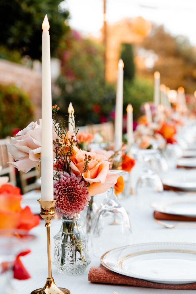Colorful spring Las Vegas micro wedding reception tablescape with taper candles and colorful florals at Mid Century Manor