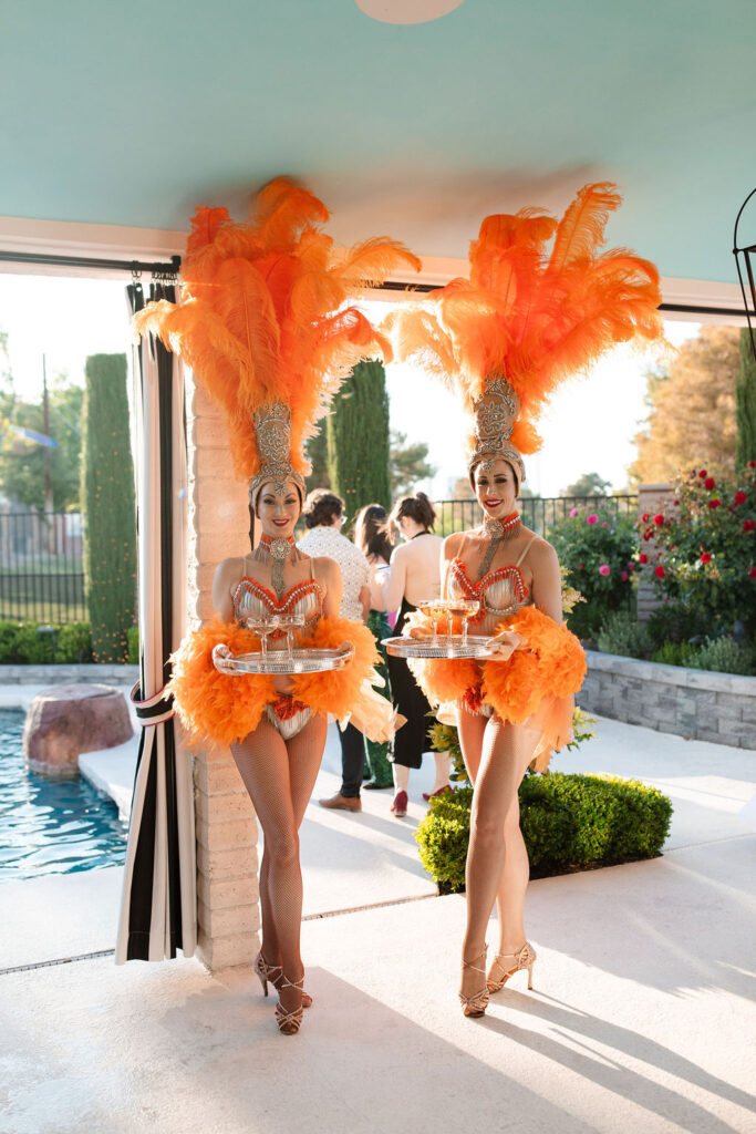 Showgirls serving champagne at Mid Century Manor wedding reception