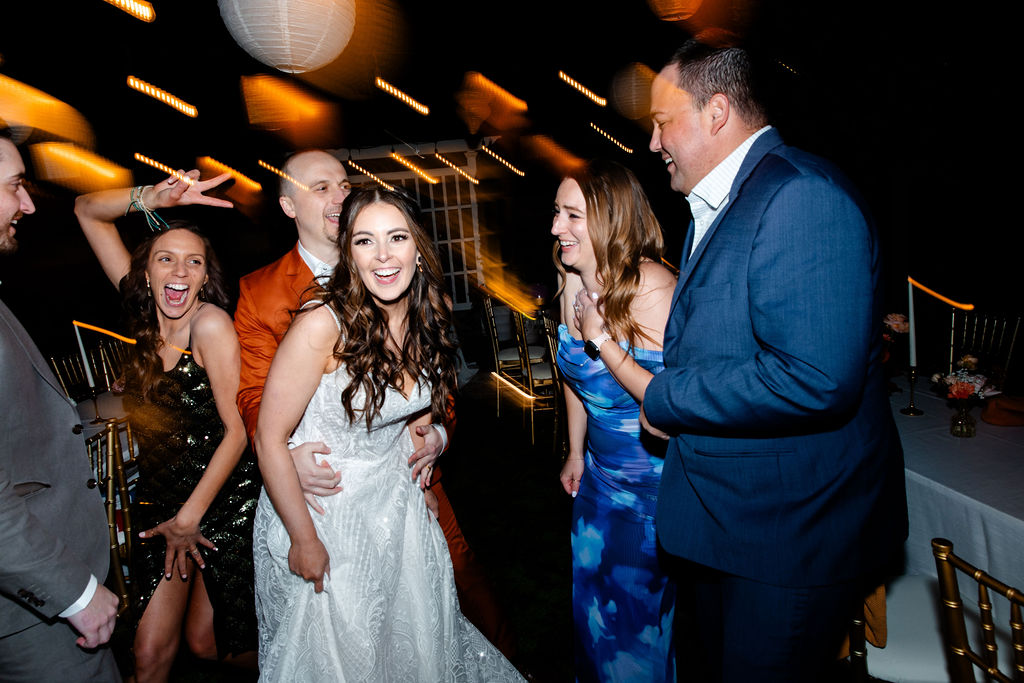 Bride and groom dancing with guests during their Mid Century Manor wedding reception in Las Vegas