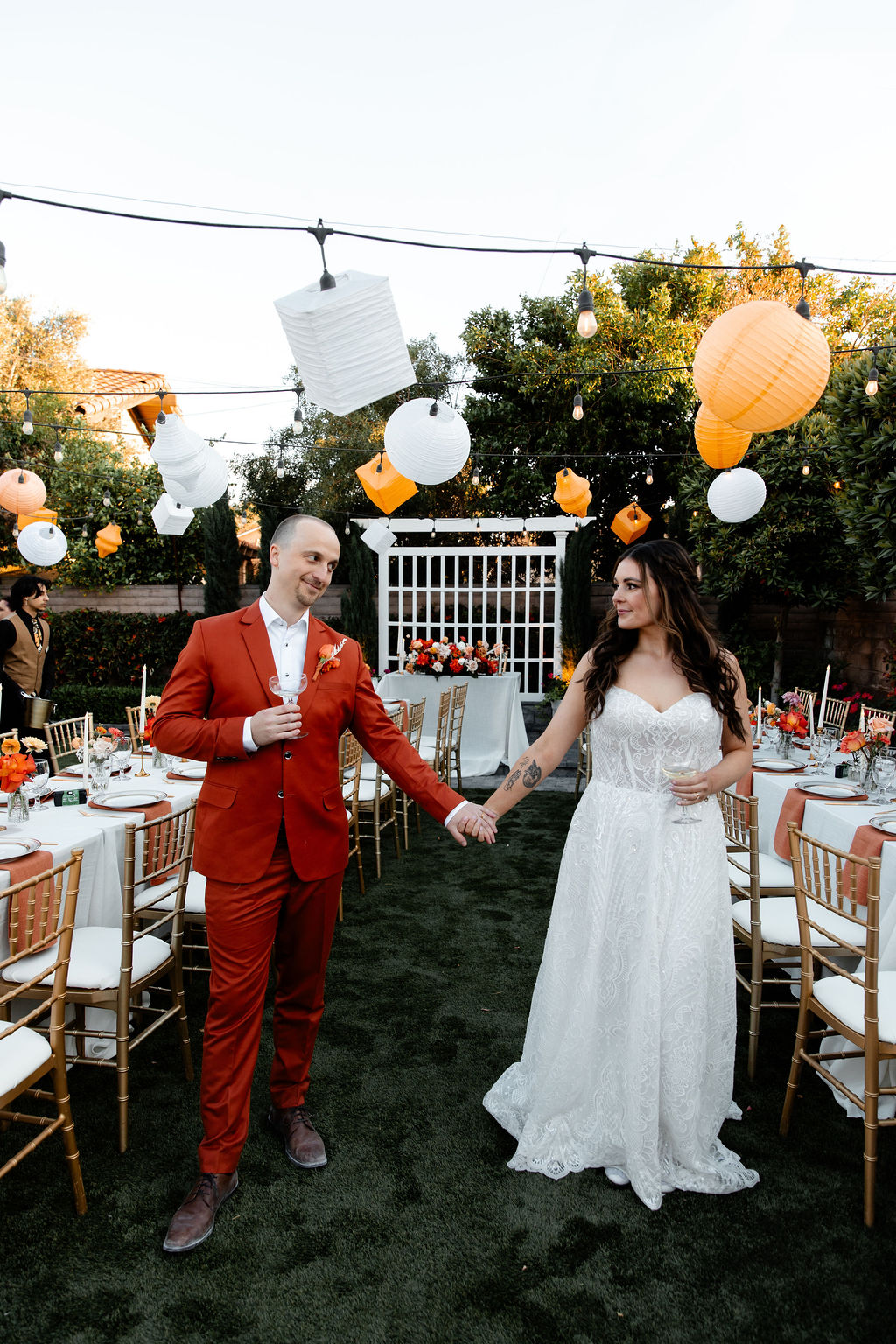 Bride and groom holding hands in their reception space at Mid Century Manor in Las Vegas