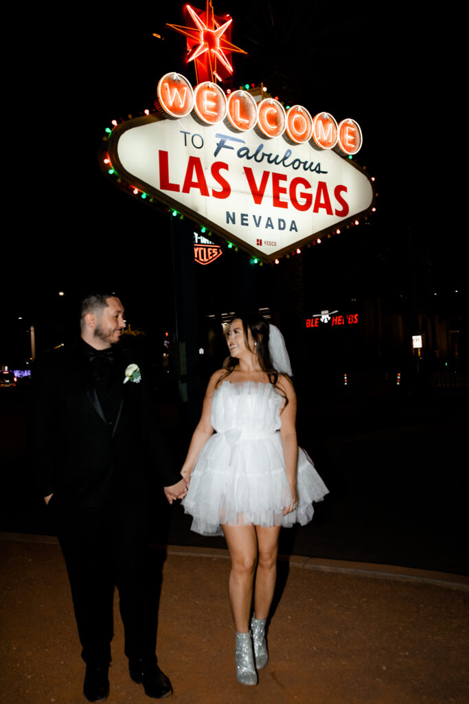 Nighttime Las Vegas elopement photos in front of the Welcome to Fabulous Las Vegas sign