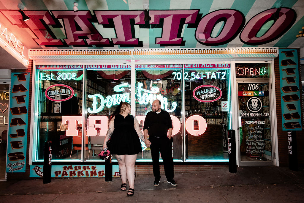 Couple posing in front of Downtown Tattoo on Fremont Street