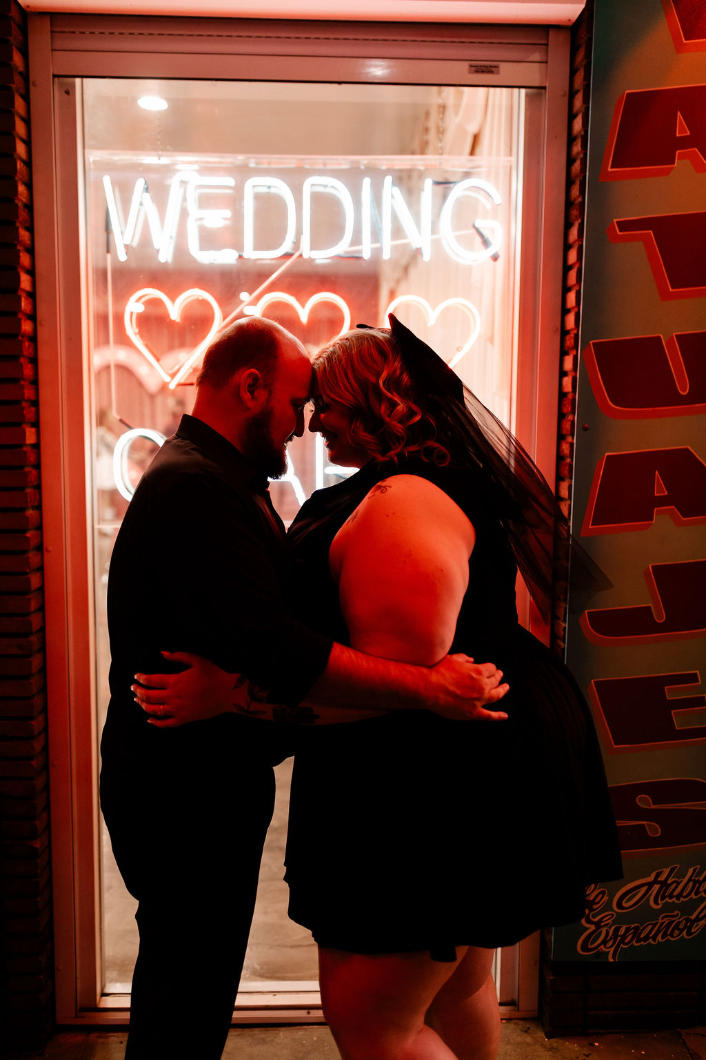 Bride and groom posing in front of the original Sure Thing Chapel in Las Vegas
