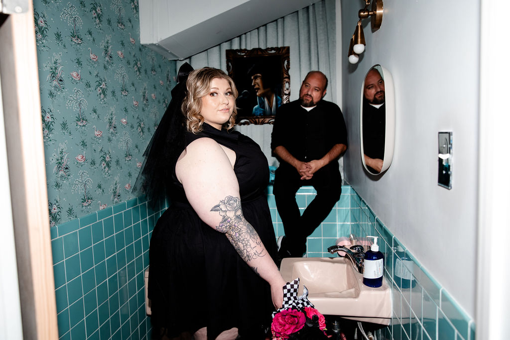 Bride and groom posing for their Sure Thing Chapel elopement photos in the bathroom