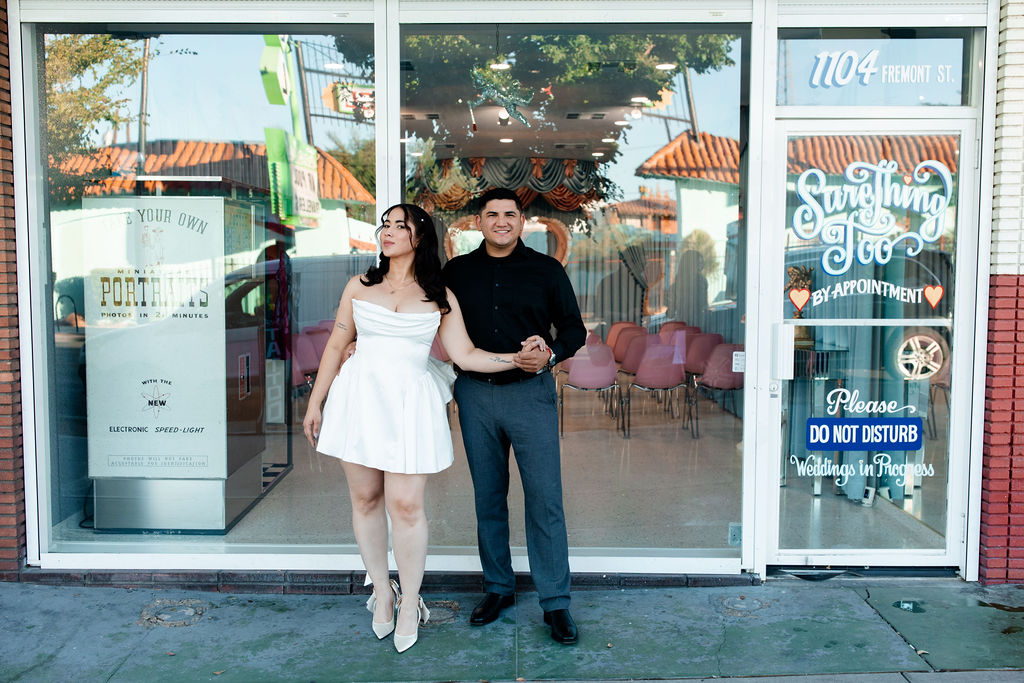 Bride and groom posing in front of Sure Thing Too in Las Vegas