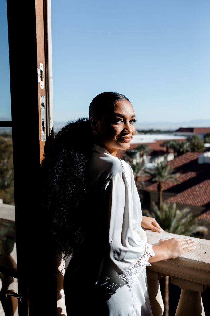 Bride posing on the balcony of her JW Marriott Las Vegas suite