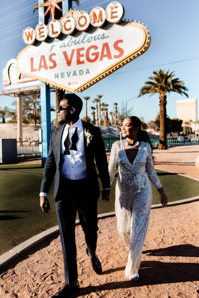 Bride and groom posing in front of the Welcome to Fabulous Las Vegas sign