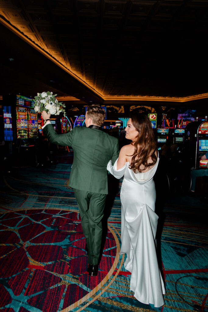 Bride and groom walking through the JW Marriott casino in Las Vegas
