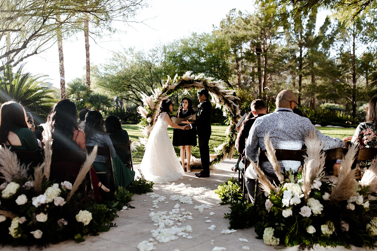 Bride and g room holding hands during their outdoor JW Marriott Las Vegas elopement ceremony