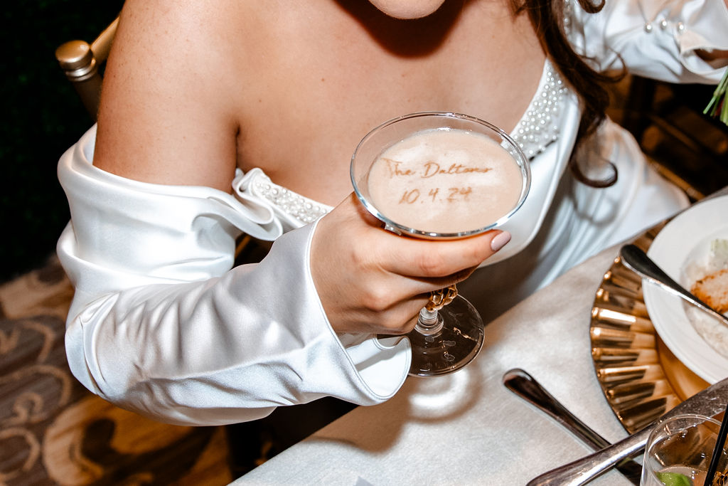 Bride holding custom drinks from their JW Marriott Las Vegas wedding reception