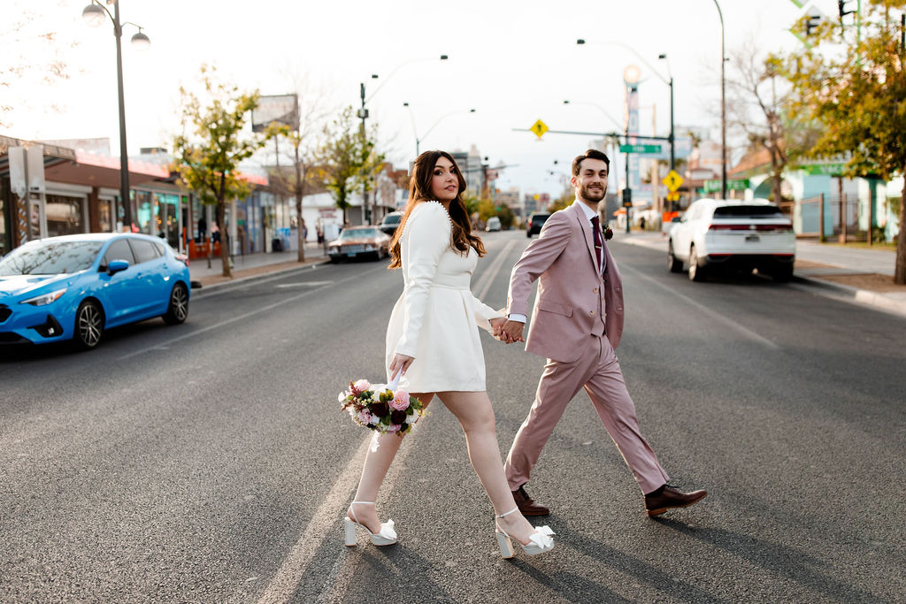Bride and groom crossing the street for their Fremont Street wedding photos