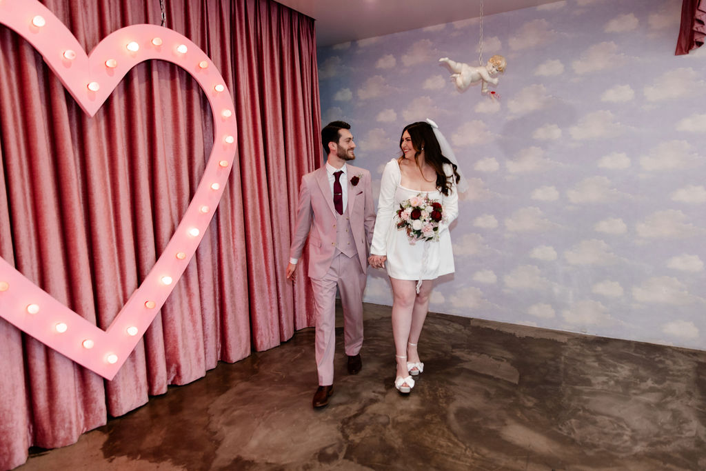 Bride and groom posing for photos at Sure Thing Chapel in Las Vegas
