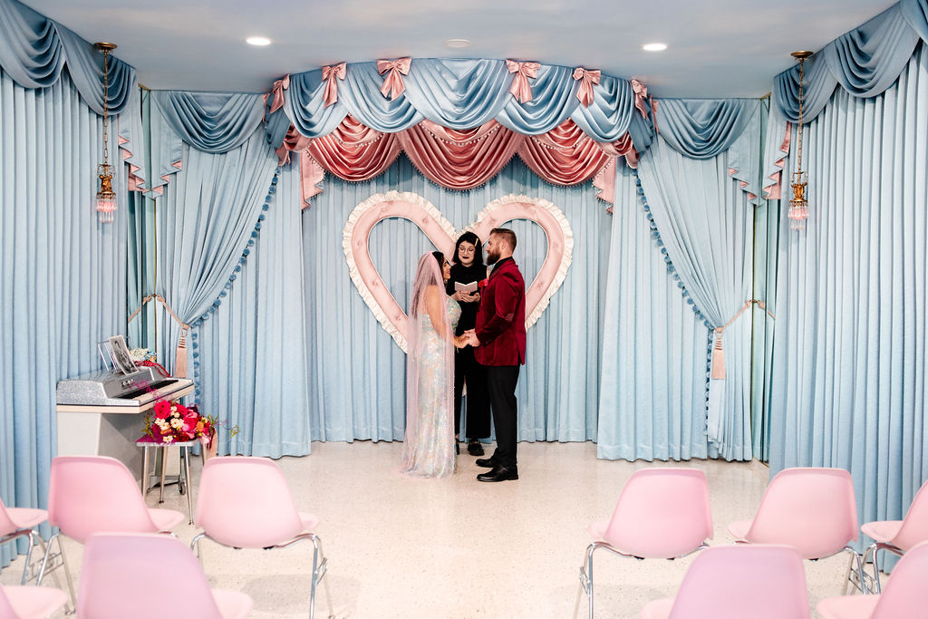 Bride and groom holding hands during their ceremony at Sure Thing Too in Las Vegas