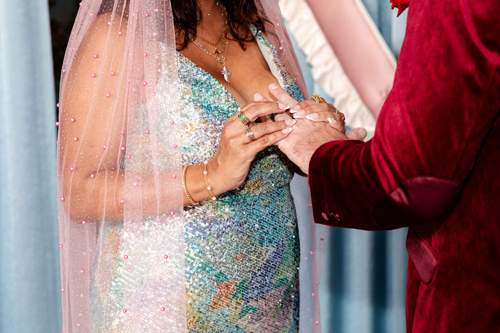Close up photo of a bride and groom exchanging rings during their ceremony