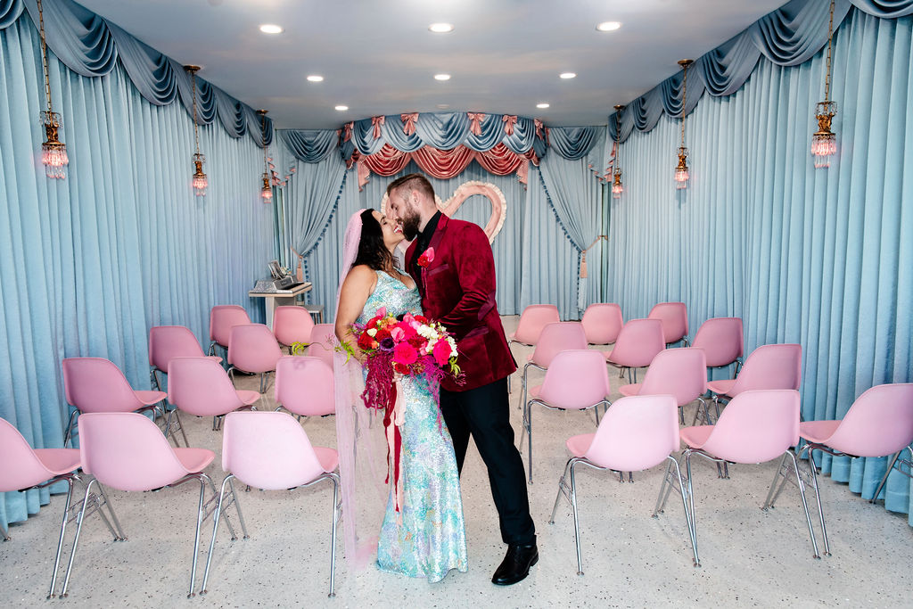 Bride and groom posing at the end of the aisle at Sure Thing Too